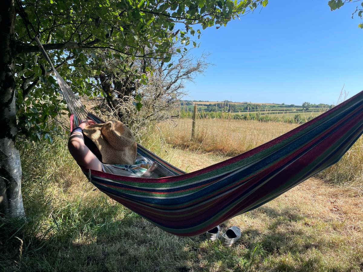 person relaxing outside glamping tent